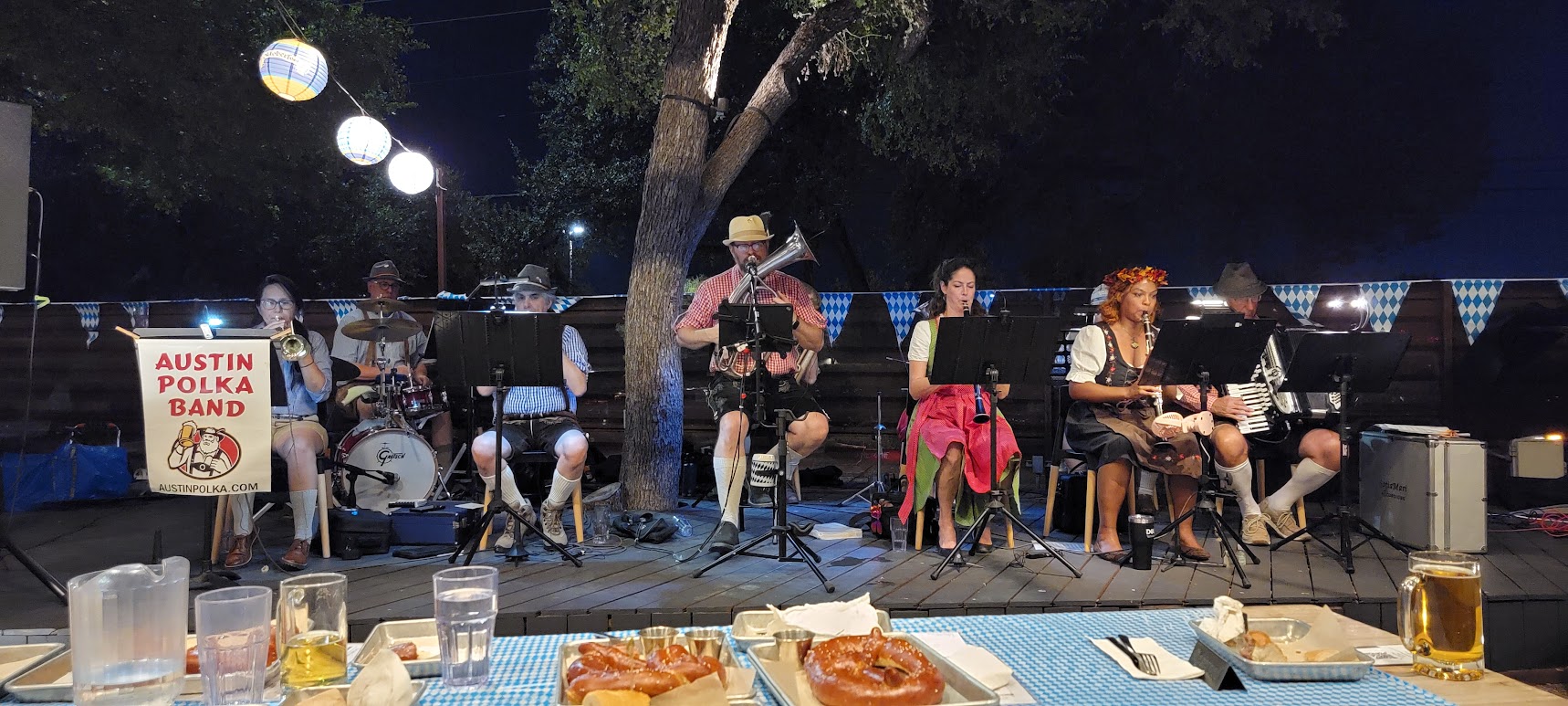 Evening biergarten set with string lights, pretzels and steins