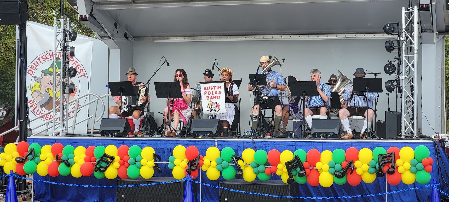 Austin Polka Band at Deutschen Fest with a festive balloon garland